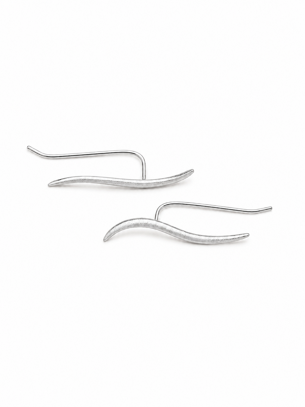 Ecommerce product view of the Face Forward ear climber earrings in 18K white gold vermeil, showing the mirrored pair's matte tapered wave fronts, slim polished back wires, U-shaped connections, and lightweight thread-through construction on a pure white background.