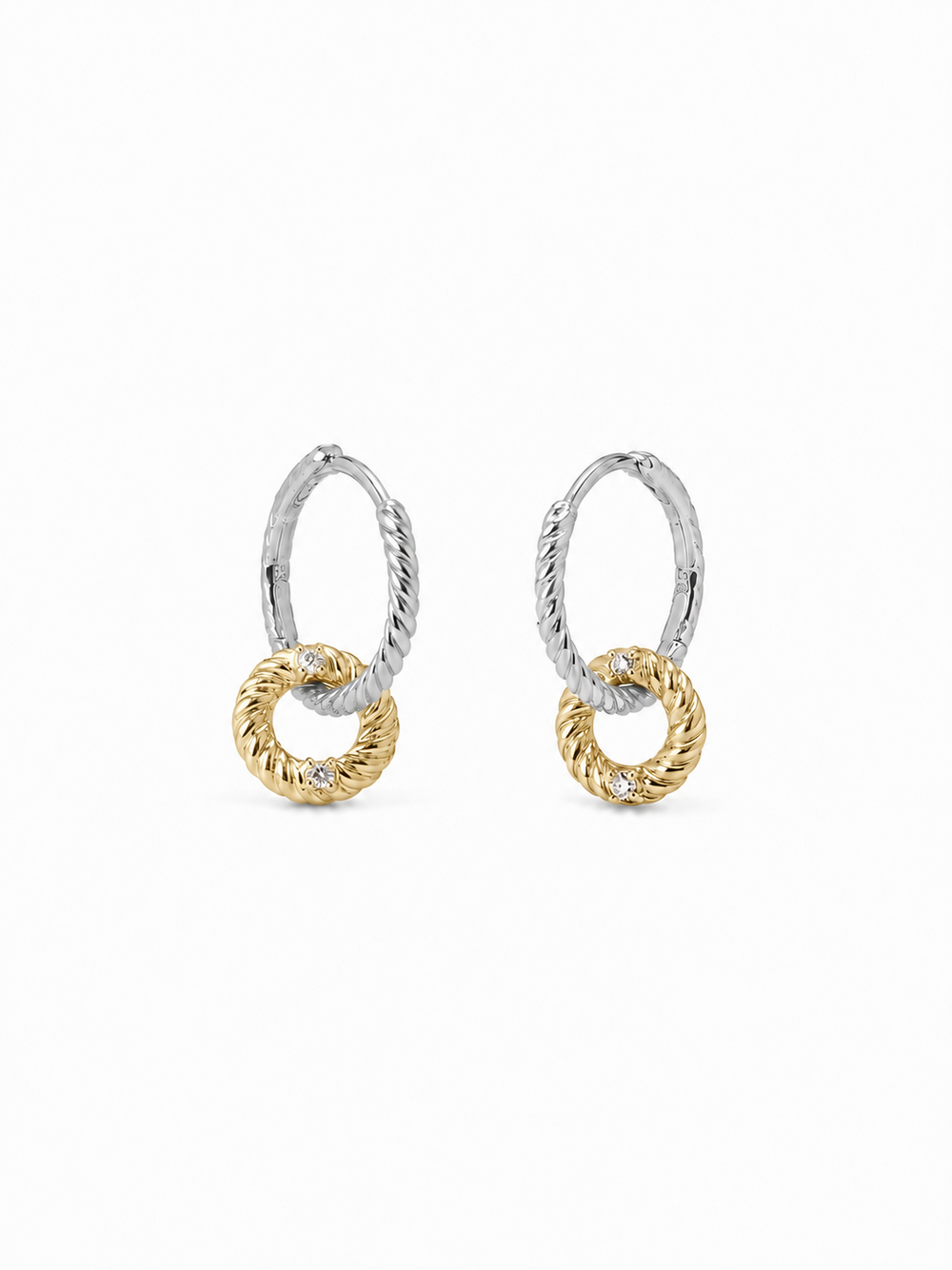Pair of interlocking loop earrings with white-gold twisted upper huggies and smaller yellow-gold rope-textured drop loops, photographed on a pure white background.