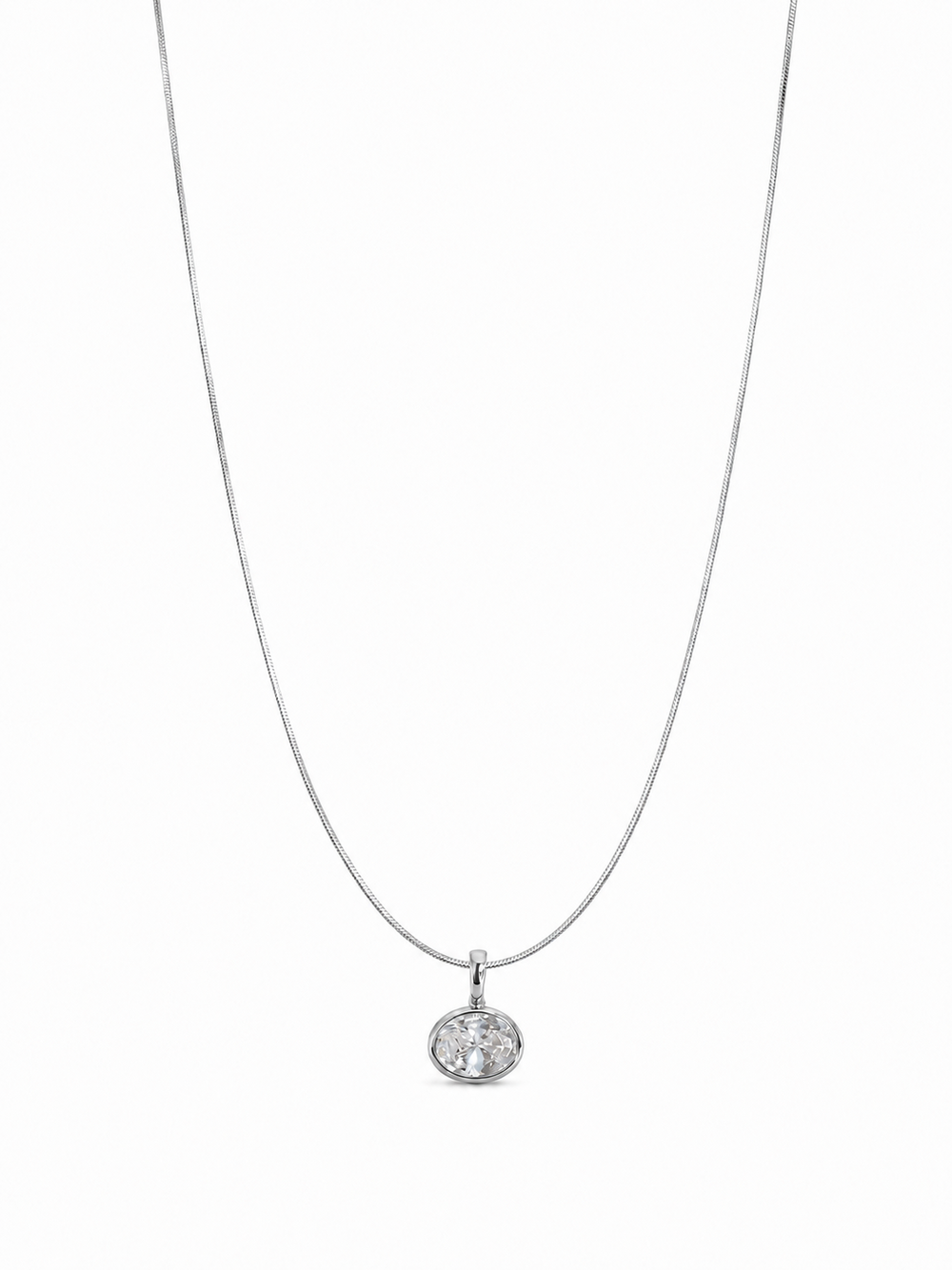 Petite single-stone white-gold bezel pendant on a fine 0.65 mm side snake chain, photographed on white.