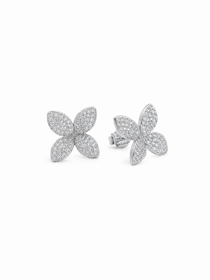 Ecommerce product view of the 3D Four-Petal Pavé Stud Earrings in 18K white gold vermeil, showing the pair's lifted marquise-shaped petals, dense white pavé stones, polished white-gold rims, posts, and butterfly backs on a pure white background.