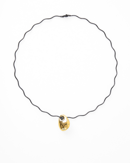Elegant necklace with a removable gold-plated bottle shape pendant on a wavy black gold vermeil chain, showcased on a clean white backdrop