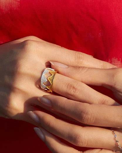 Close-up of hands with jewelry against a red fabric background