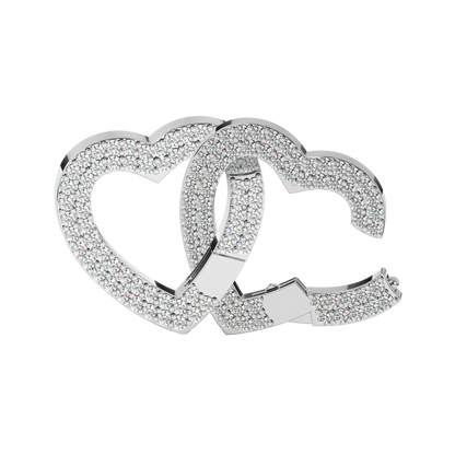 Close-up view of two interlocked silver heart charms encrusted with sparkling stones. The elegant design features overlapping hearts, showcasing a timeless and sparkling silver finish.