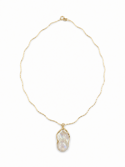 Irregular freshwater baroque pearl pendant on the yellow-gold Free-Willed Sculptural Necklace, shown on white.