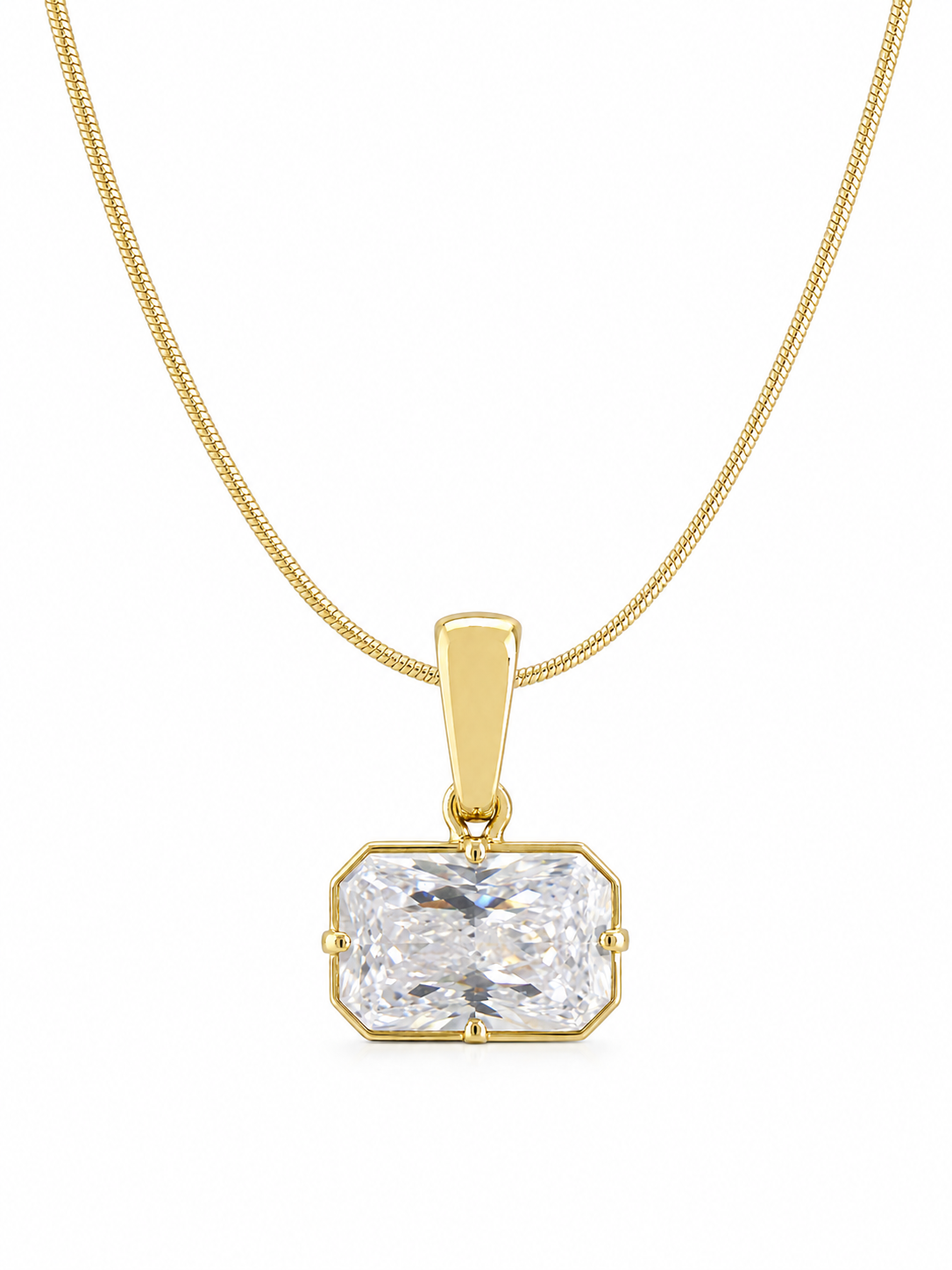 Wide clear emerald-cut pendant in a yellow-gold setting on a fine 0.65 mm side snake chain, photographed on white.
