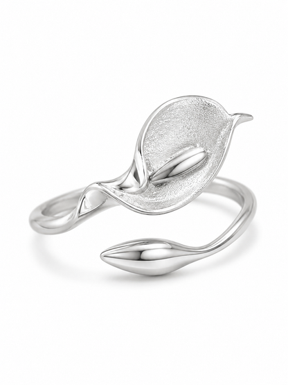 Ecommerce product view of the Calla Me Maybe adjustable sculptural ring in white gold vermeil, showing its matte calla lily flower, polished central detail, open wrap band, and pointed bud-shaped end on a pure white background.