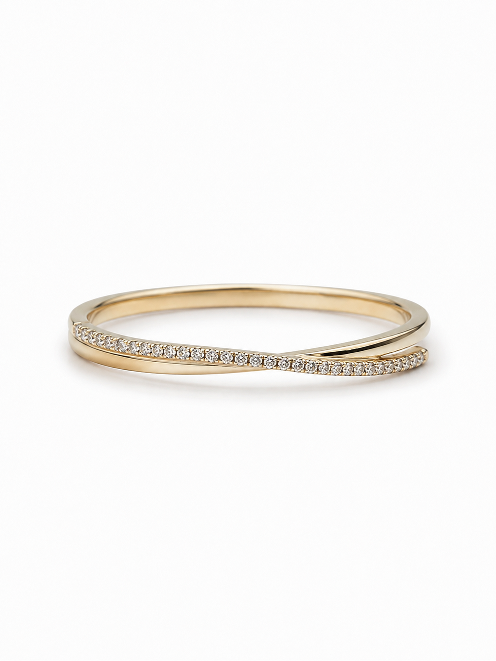 Horizontal yellow gold asymmetric crossover ring with a slim pavé arm and polished tapered arm