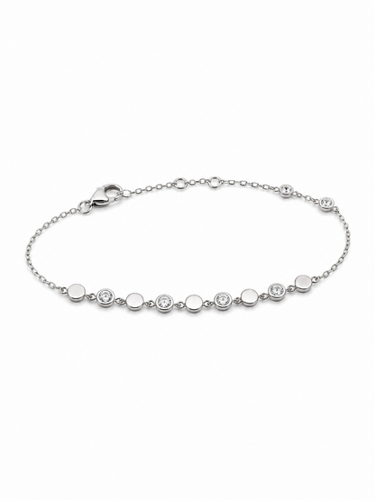 White gold bracelet with alternating polished discs and clear bezel-set stones on a white background.