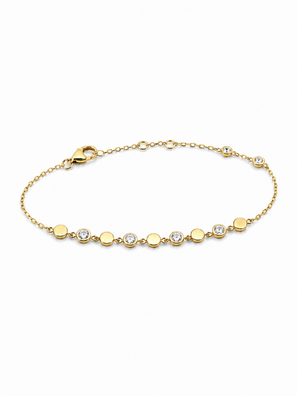 Yellow gold bracelet with alternating polished discs and clear bezel-set stones on a white background.