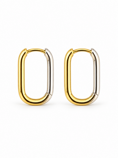 Pair of elongated reversible Link Huggie Hoop earrings in polished yellow gold and white rhodium, shown closed on a white background