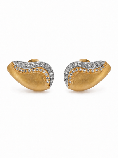 Pair of Double Wave Sculptural Ear Grill Studs in matte yellow gold with white-rhodium upper waves and clear pavé stones on a white background