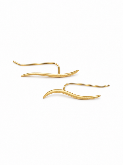 Ecommerce product view of the Face Forward ear climber earrings in 18K yellow gold vermeil, showing the mirrored pair's matte tapered wave fronts, slim polished back wires, U-shaped connections, and lightweight thread-through construction on a pure white background.