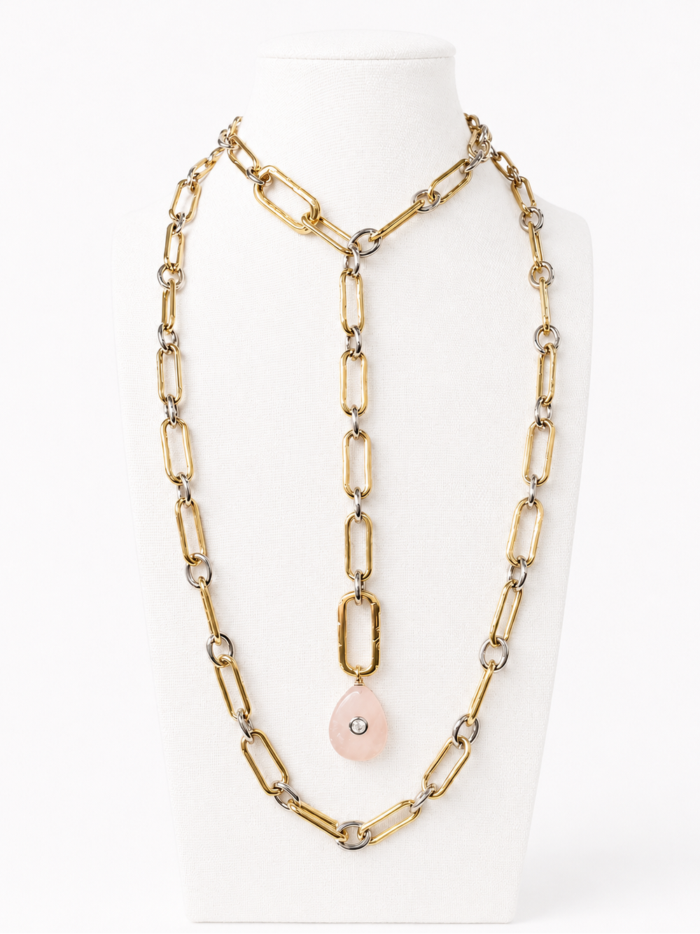 Long open-ended duo-tone link necklace styled in layers and a lariat on a nearly white bust