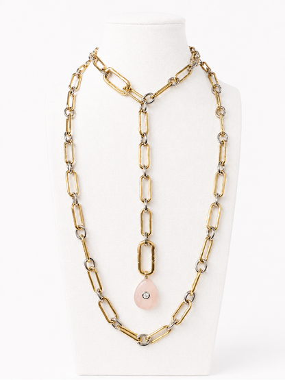Long open-ended duo-tone link necklace styled in layers and a lariat on a nearly white bust