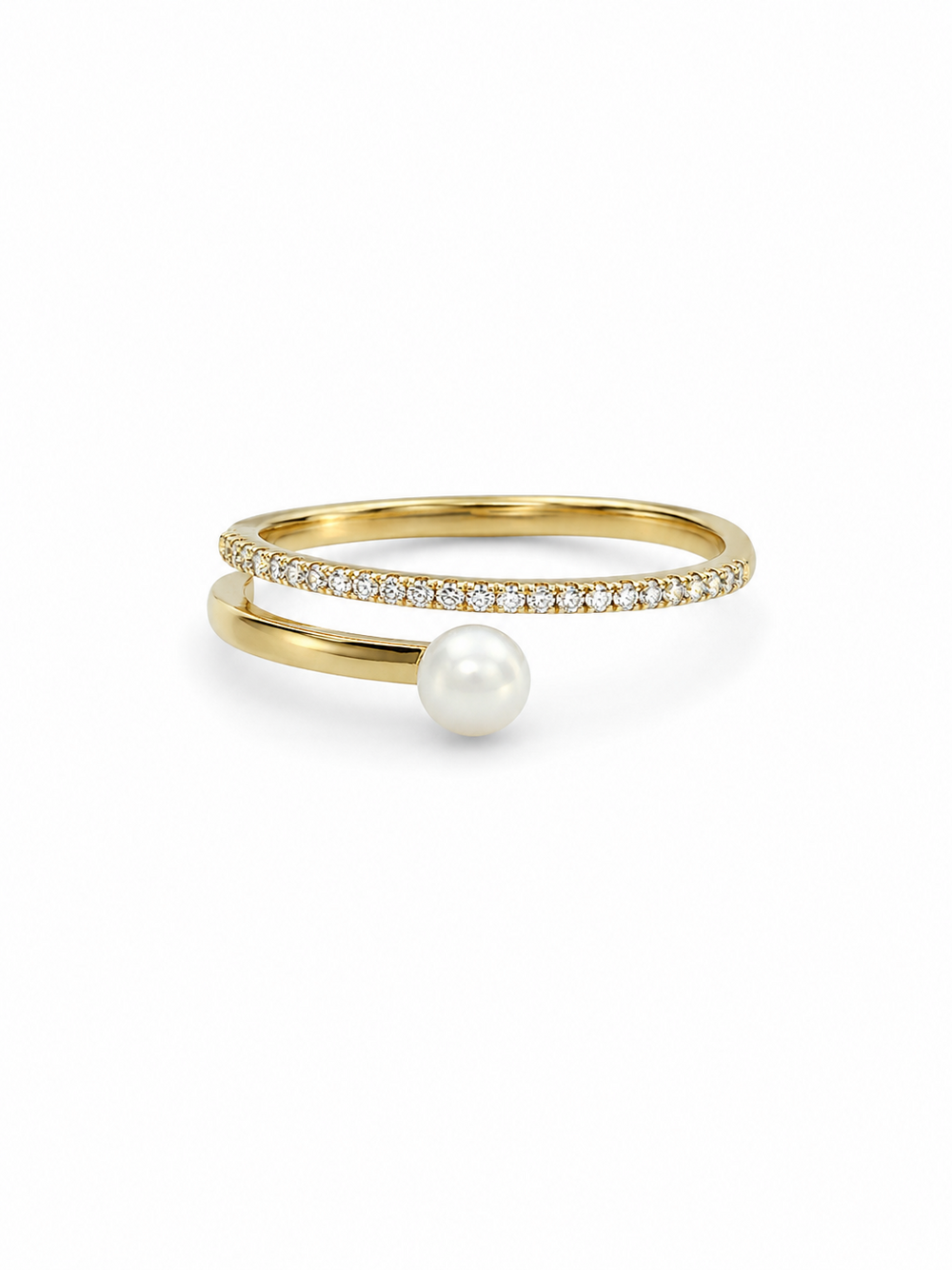 Freshwater pearl crossover ring in yellow gold with one slim clear pavé arc and one smooth pearl-tipped arc on a white background.
