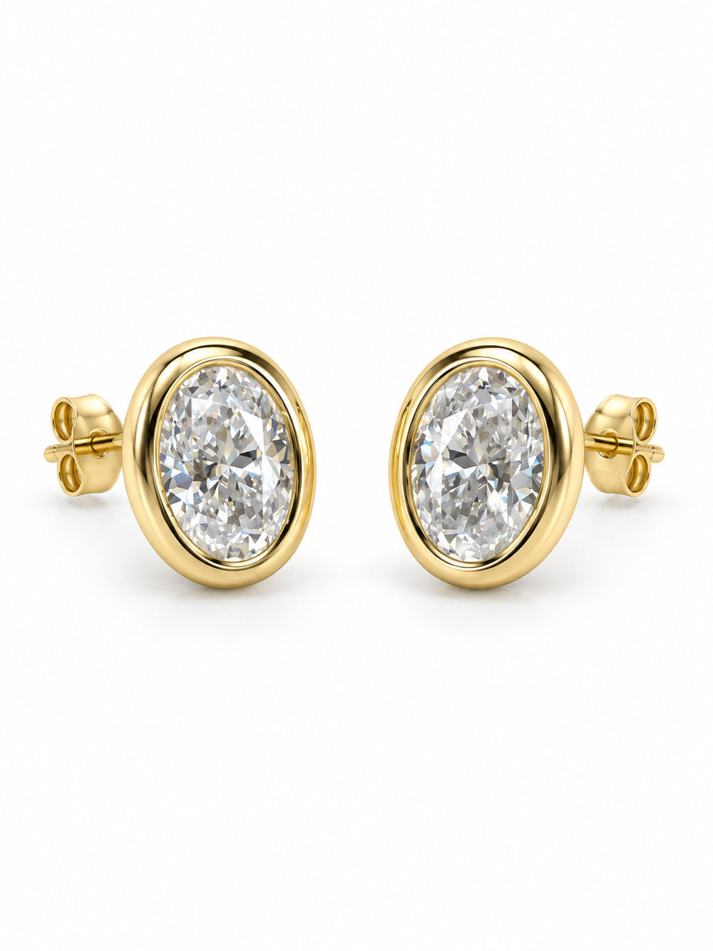 Three-quarter view of Golden Hour oval moissanite bezel studs with posts and butterfly backs