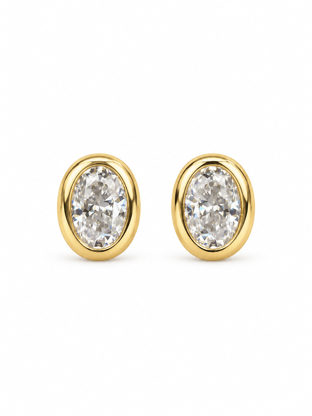 Golden Hour yellow-gold moissanite bezel stud earrings with 6 by 4 millimeter oval stones