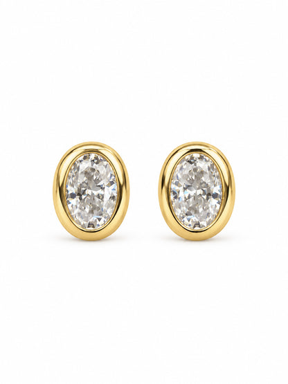 Golden Hour yellow-gold moissanite bezel stud earrings with 6 by 4 millimeter oval stones