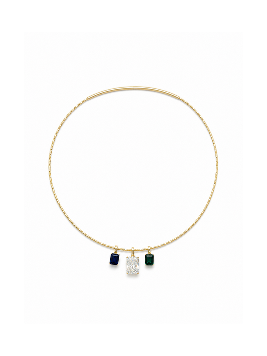 Yellow-gold sculptural collar necklace styled with three removable emerald-cut pendants in sapphire blue, clear and emerald green, demonstrating the interchangeable three-stone configuration on a white background.