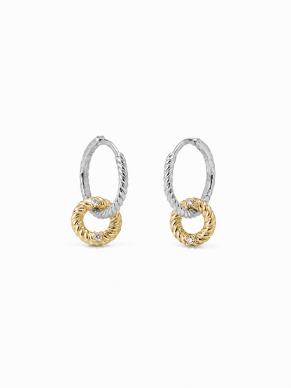 Pair of interlocking loop earrings with white-gold twisted upper huggies and smaller yellow-gold rope-textured drop loops, photographed on a pure white background.