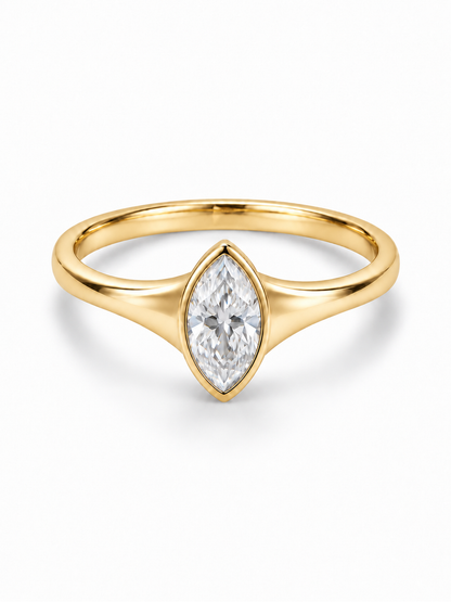 Yellow gold ring with solid tapered shoulders and a bezel-set marquise moissanite