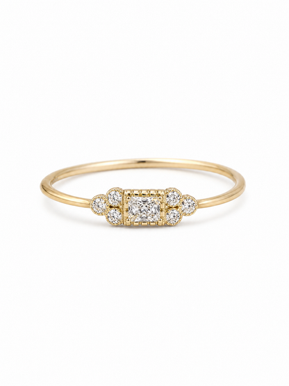 Mina Art Deco cluster ring in yellow gold with a clear princess-cut center stone and six round side stones
