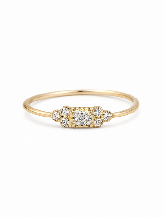 Mina Art Deco cluster ring in yellow gold with a clear princess-cut center stone and six round side stones