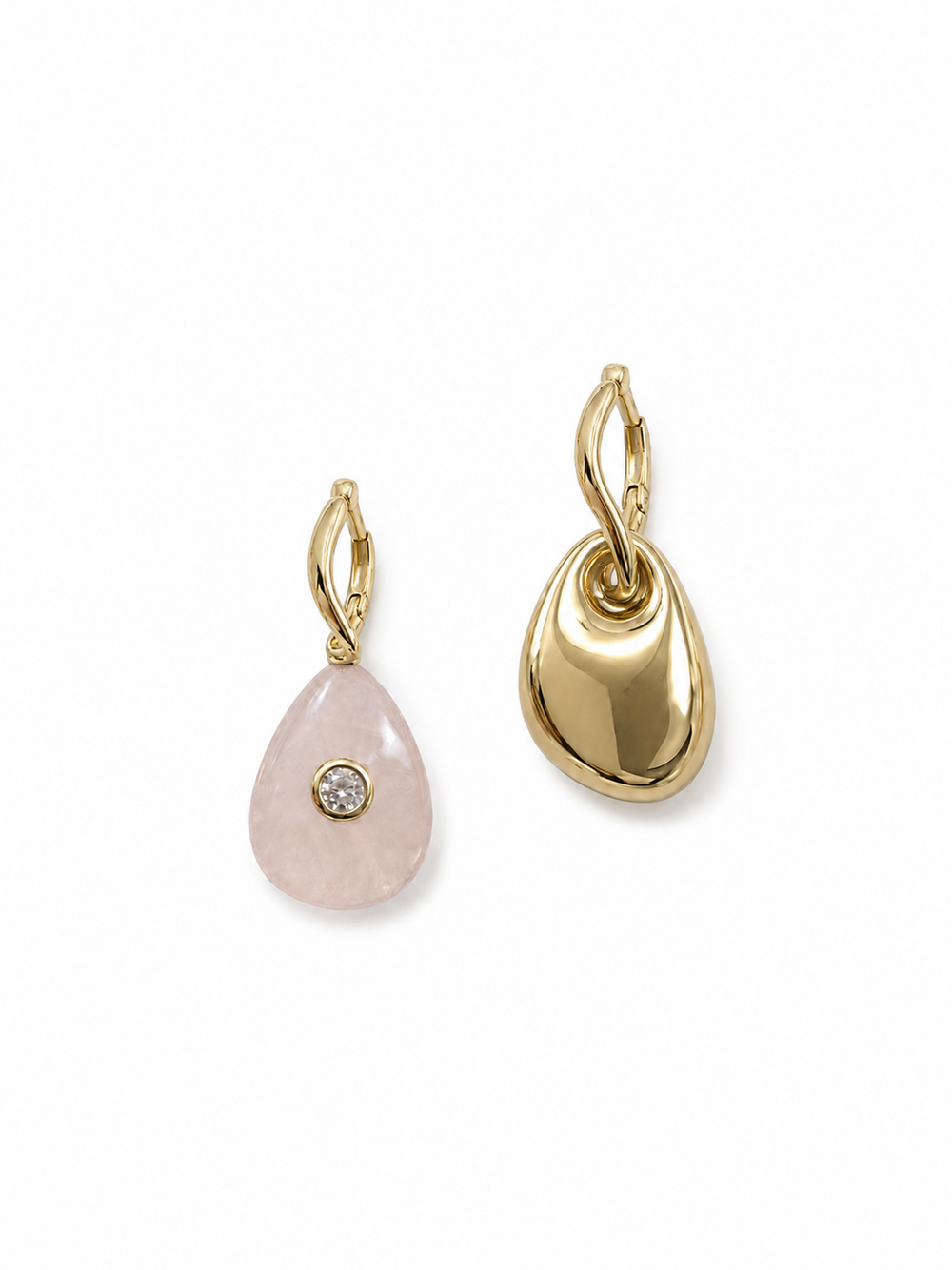 Mismatched yellow gold huggie earrings with a pale pink rose quartz teardrop charm and polished gold pebble charm on a white background