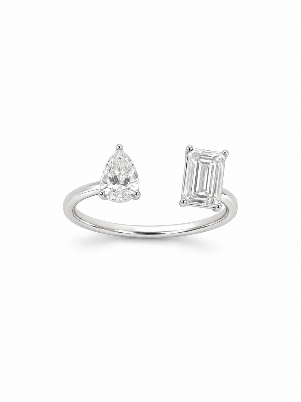 White gold adjustable bypass ring with a clear pear-cut stone and emerald-cut stone on a white background.