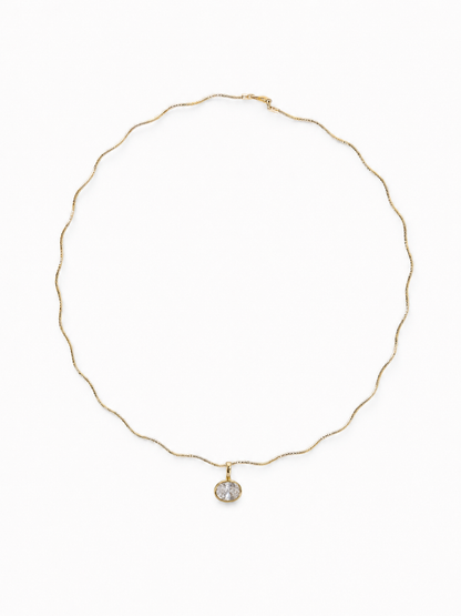 Petite Single-Stone Bezel Pendant hanging from the Free-Willed scalloped sculptural necklace in matching yellow gold, shown on white.