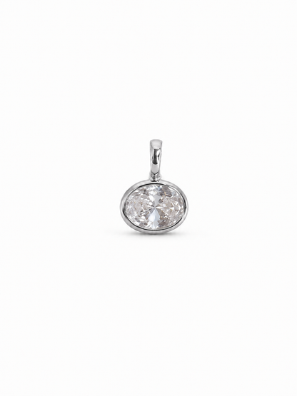 Petite single-stone bezel pendant in white gold with a clear horizontal oval faceted stone, shown without chain