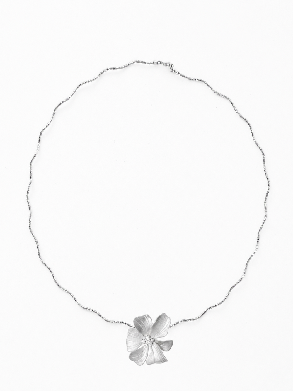 Full ecommerce product view of the Reine Clayful necklace in 18K white gold vermeil, featuring the handmade matte sculptural peony pendant with white cubic zirconia accents on The Link's flexible wavy chain against a pure white background.