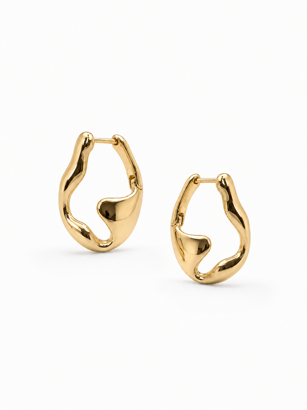 Mirrored pair of sculptural yellow-gold wave hoop earrings, with the left earring higher and the right earring slightly lower on a white background.