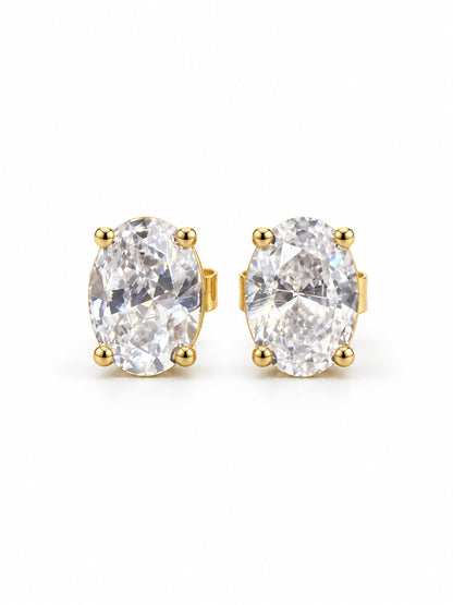 Pair of clear oval four-prong stud earrings in polished yellow-gold color on a white background