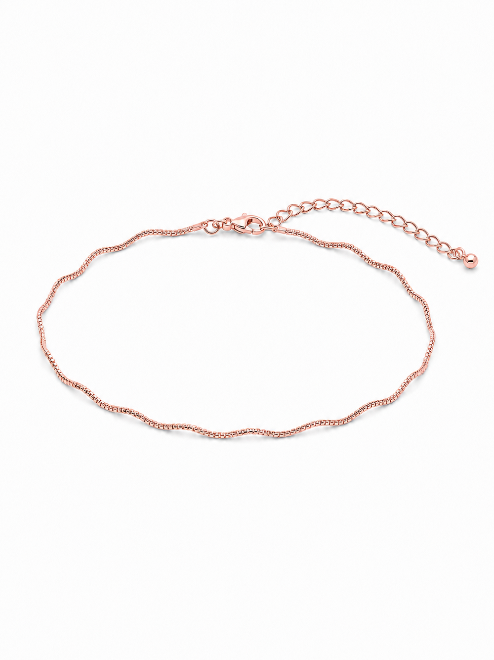 Solene wavy bracelet in rose gold, styled in a small horizontal wrist-sized oval with its undulating chain profile and 2-inch adjustable extension fully visible on white.