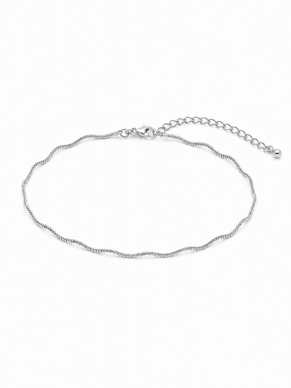 Solene wavy bracelet in white gold, showing its fine reflective sculptural chain, compact wrist proportions, lobster clasp and 2-inch extension on a white background.