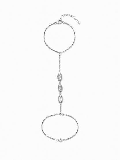 Marquise link hand chain in white gold with an adjustable bracelet wrist section, lobster clasp, extender, and three open stone-set stations on white.