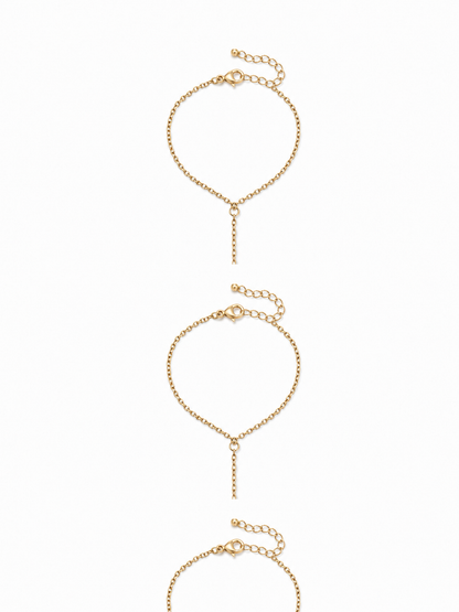 Marquise link hand chain in yellow gold with an adjustable bracelet wrist section, lobster clasp, extender, and three open stone-set stations on white.