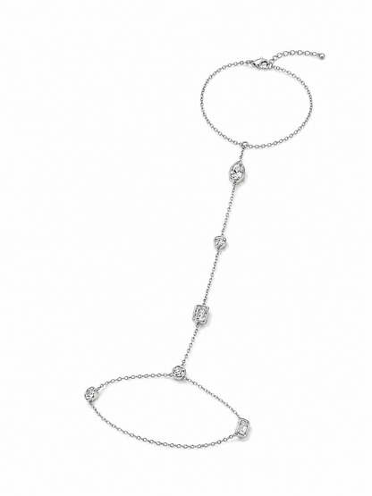 Mixed bezel hand chain in white gold with an adjustable bracelet wrist section, lobster clasp, extender, and clear bezel-set stones on white.