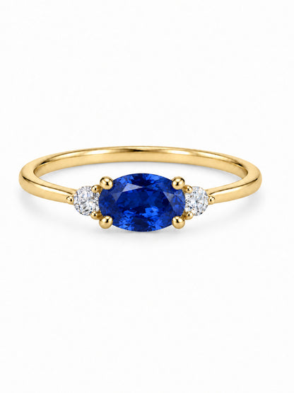 Three Wishes Oval Ring in yellow gold tone with a sapphire-blue oval center stone and two round clear side stones