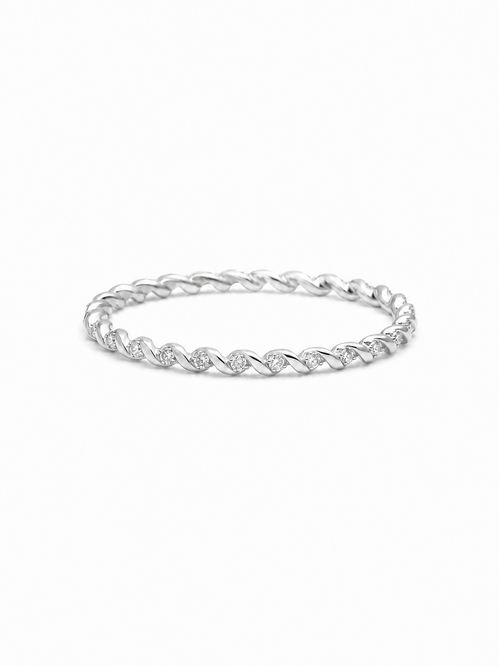 Slim twisted pavé band ring in white gold with repeating polished diagonal folds and tiny clear stone accents on a white background.