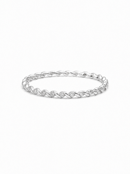 Slim twisted pavé band ring in white gold with repeating polished diagonal folds and tiny clear stone accents on a white background.